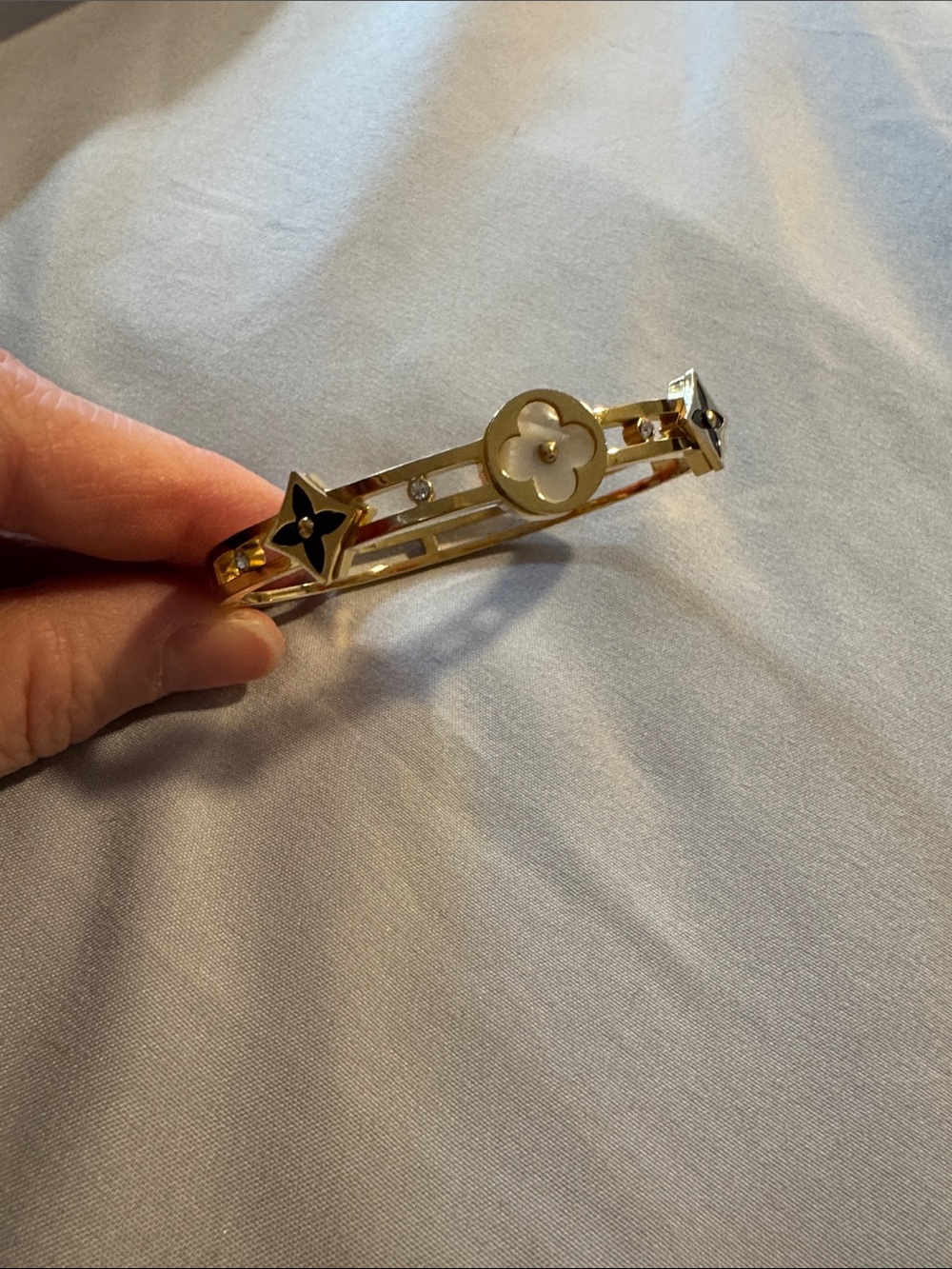 Gold-tone Bangle. Floral Motif - White & Black Accents